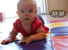 6-months-old-crawling-on-patchwork-mat-the-children's-factory