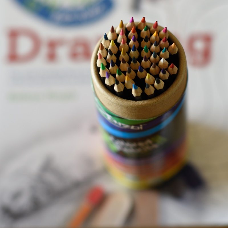 colored pencils and drawing book